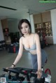 A woman riding a stationary bike in a gym.