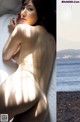 A naked woman leaning against a wall next to the ocean.